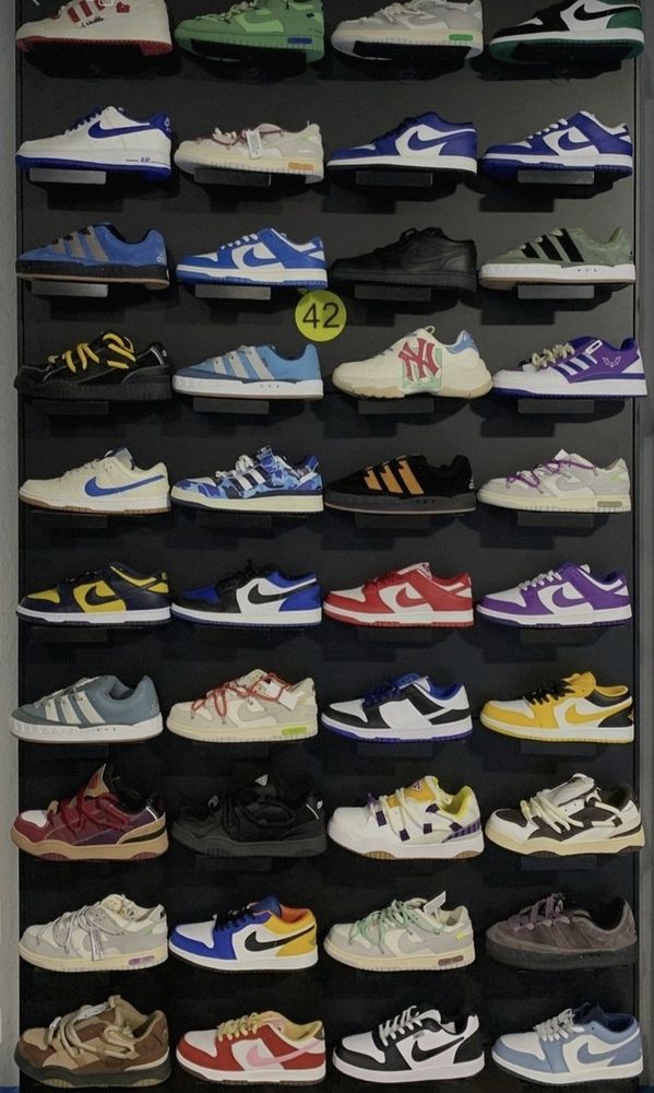 Display wall of 40 plus Dunk, Air Force 1 and Air Jordan sneakers at the factory