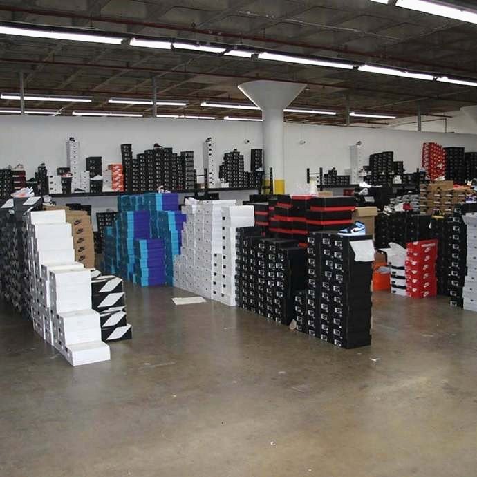 Warehouse filled with stacked branded shoe boxes